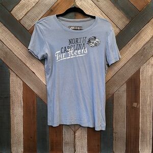 North Carolina Tarheels light blue tee. Size large fits like a medium. 
…